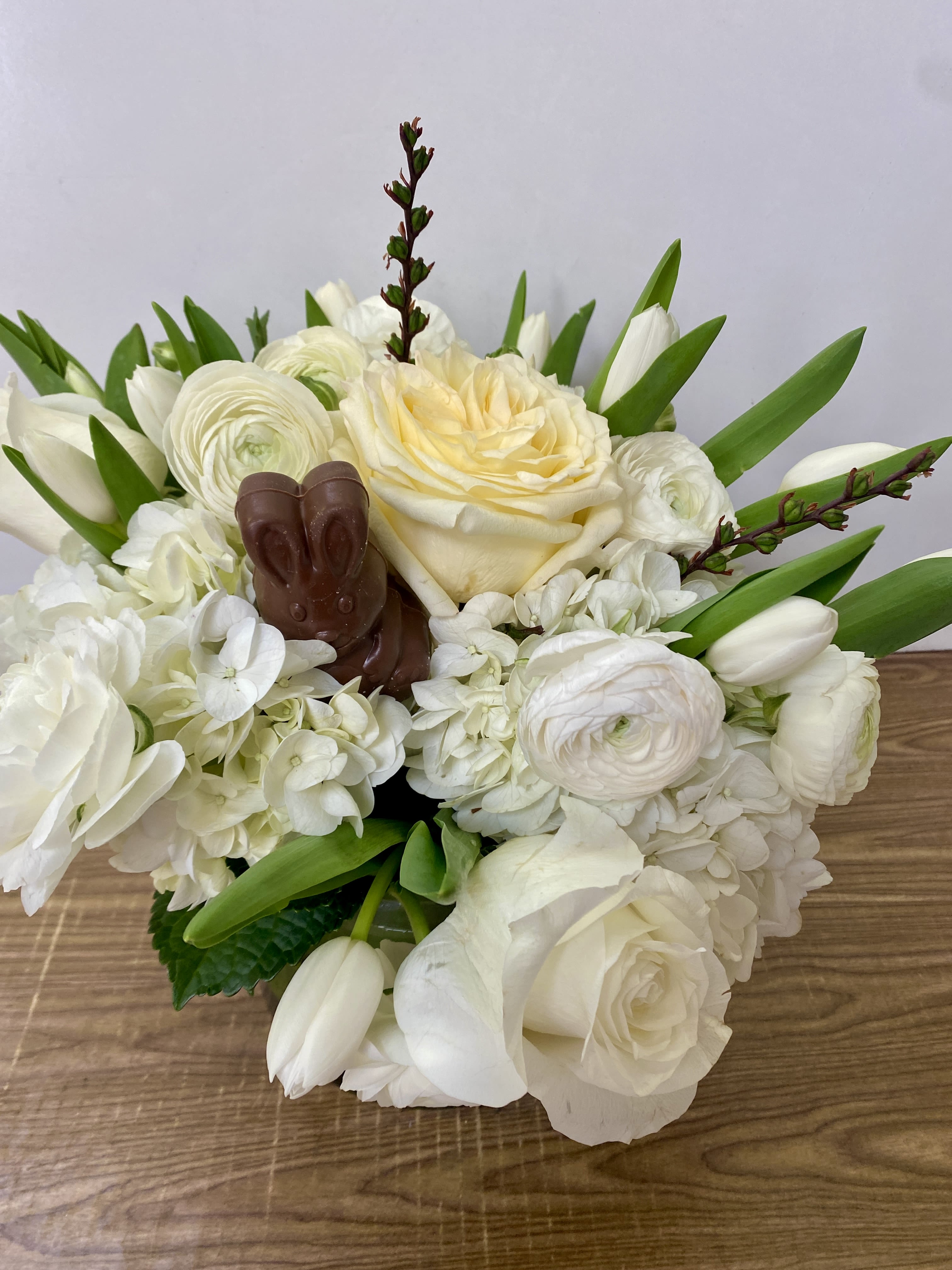 Happy Easter - White flowers in the glass waves with a chocolate bunny