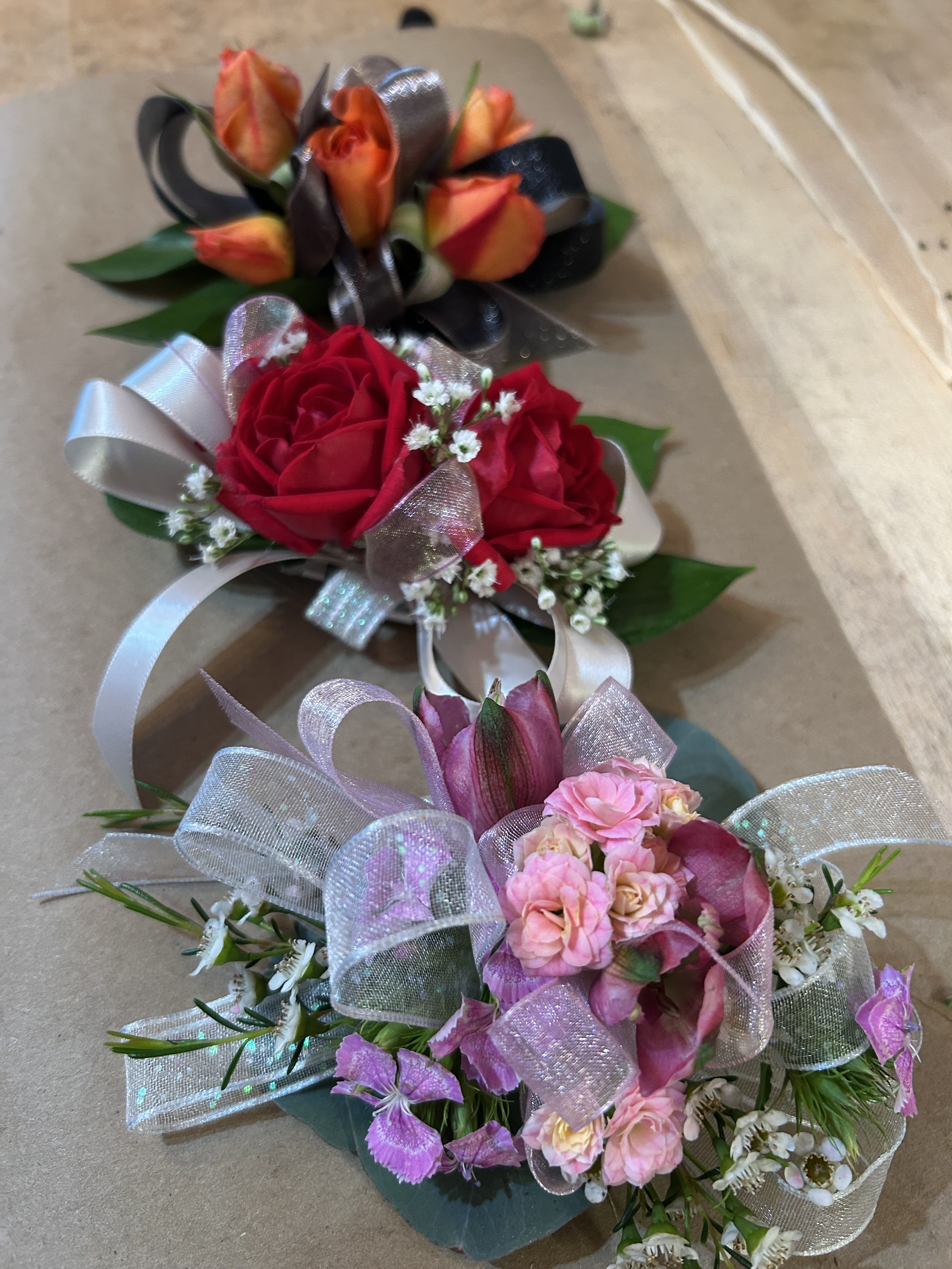 Corsage  - A classic corsage hand-tied in ribbon that compliments any outfit. A beautiful addition to any prom, formal, or wedding event. 