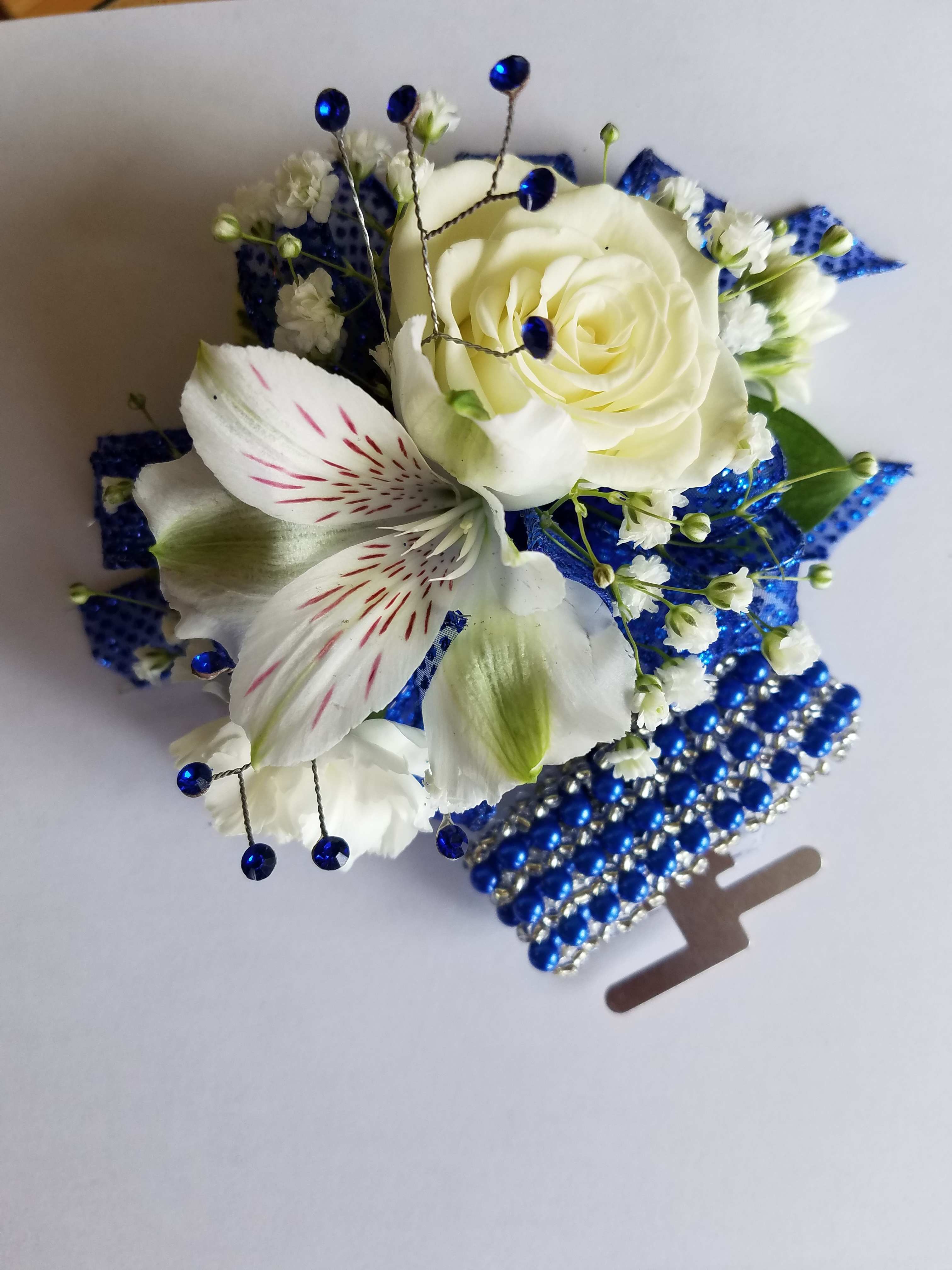 Corsage 3 Mixed Flowers Premium upgraded wristlet - This corsage has 3 mixed designers choice flowers with greens, filler, upgraded bling, and upgraded bracelet. We have all sorts of ribbon from lime green sparkle to animal print, just tell us in the special instructions what your looking for! You may also send us a picture of the dress or inspirations to our email address lvfloral@gmail.com just make sure to include your name and order number.    ALL corsage/boutonniere orders will be ready for PICK UP ONLY between 12pm-4pm the day of the event.