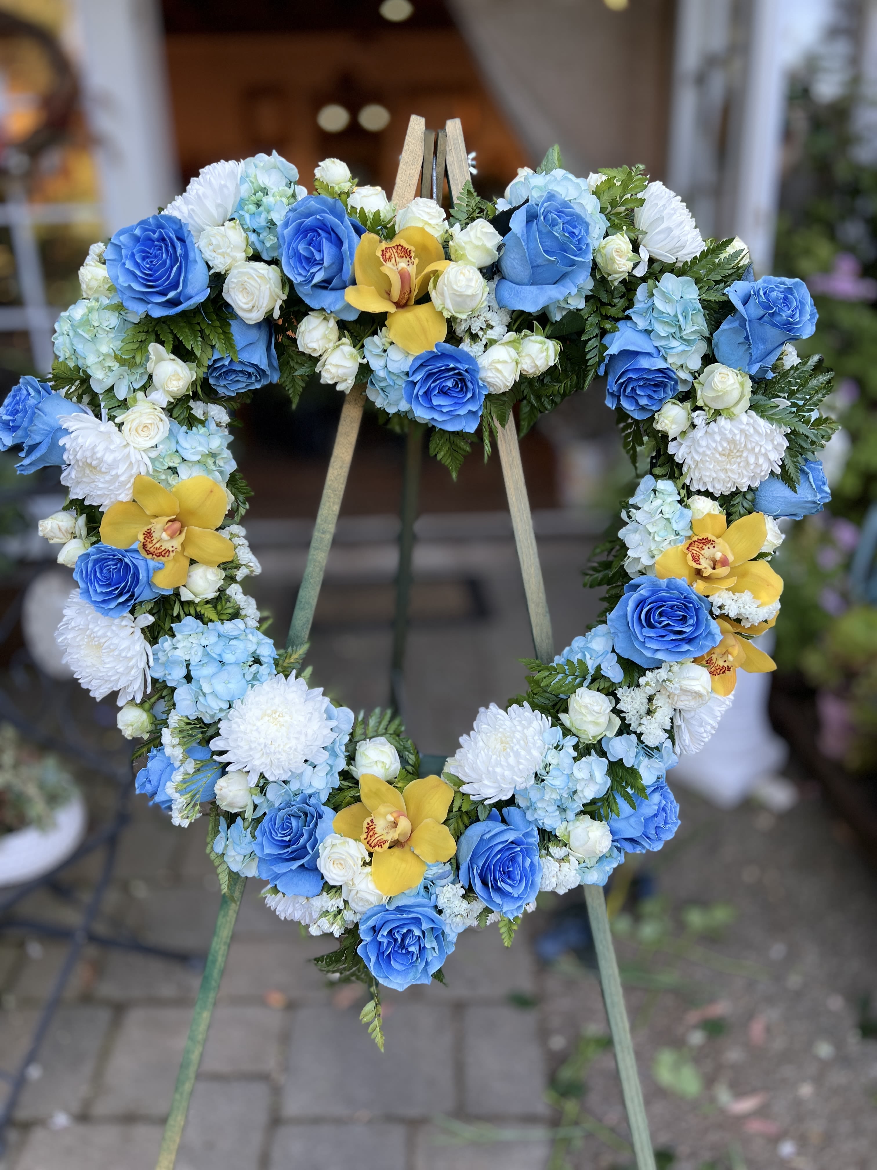 BLUE HEART WREATH - funeral wreath with blue roses, hydrangeas,  spray rose, and cymbidium orchids