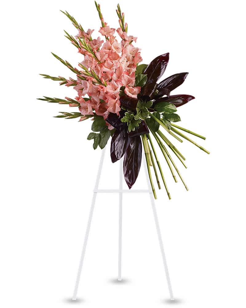 Tall standing spray with pink flower spikes and dark burgundy leaves on a white easel
