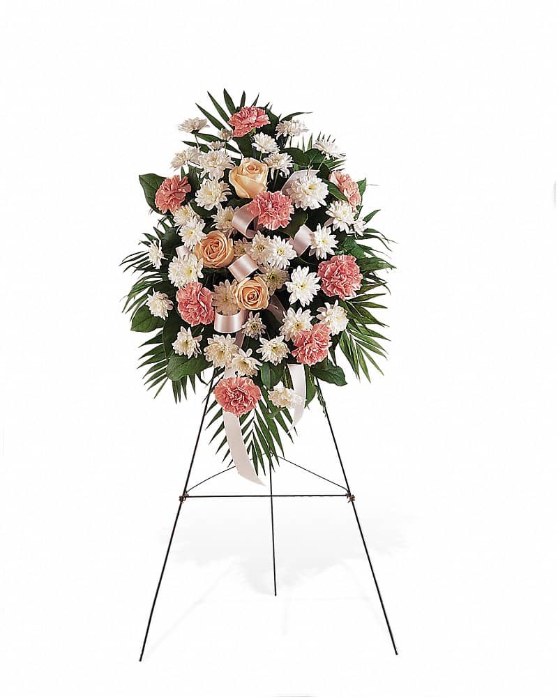 Standing spray of peach roses, pink carnations, and white daisies on a metal easel