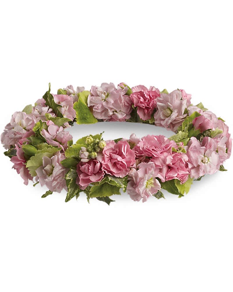 Low circular wreath of pink flowers and buds forming a ring on a white background