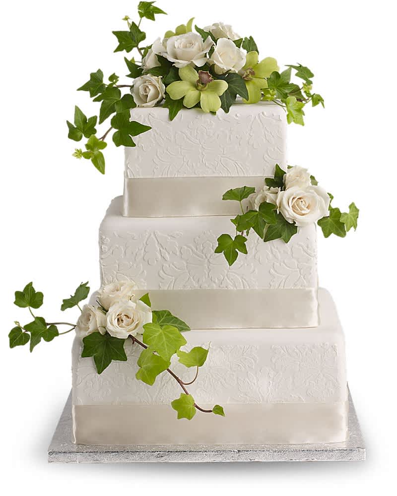 Three-tier white cake decorated with white roses and green orchids cascading with ivy