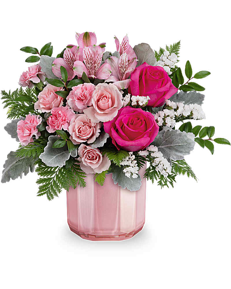 Compact arrangement of hot pink and pale pink roses with pink alstroemeria in a pink glass vase