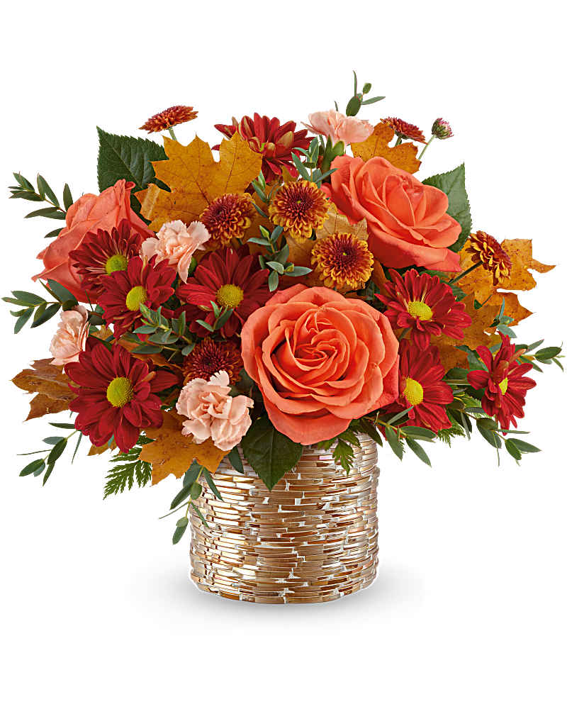 Autumn arrangement of orange roses, red mums, and carnations in a gold textured vase