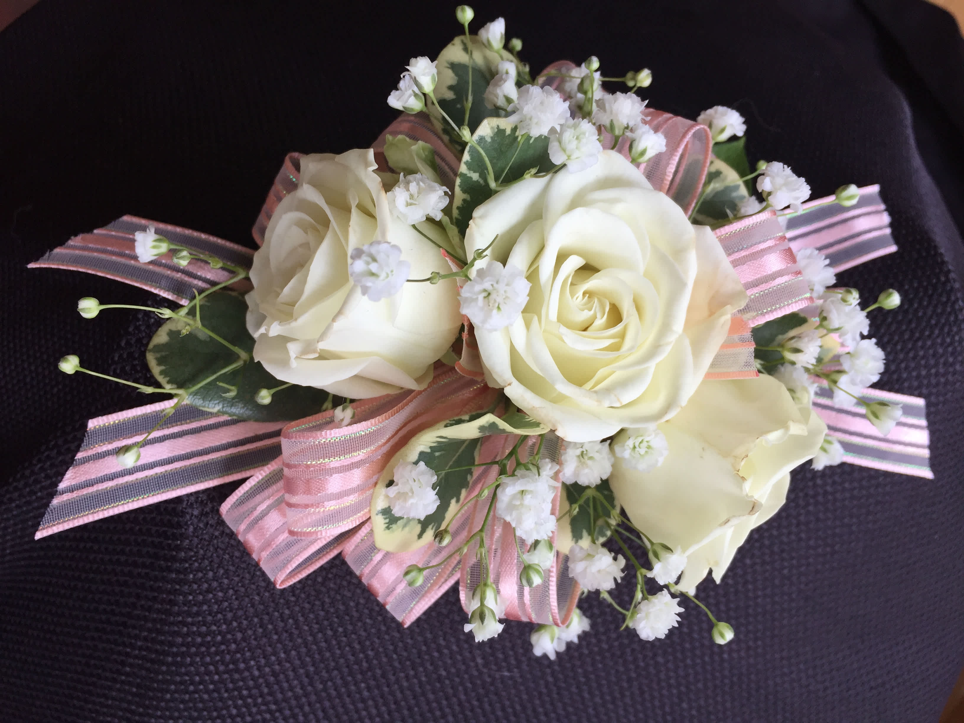 Corsage 3 rose standard -  This corsage has 3 spray roses with greens and filler. We have all sorts of ribbon from lime green sparkle to animal print, just tell us in the special instructions what your looking for! You may also send us a picture of your dress or inspirations to our email address lvfloral@gmail.com just make sure to include your name and order number.      ALL corsage/boutonniere orders will be ready for PICK UP ONLY between 12pm-4pm the day of the event. 