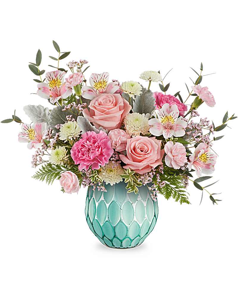 Pink roses, carnations, and white mums arranged in a teal textured glass vase