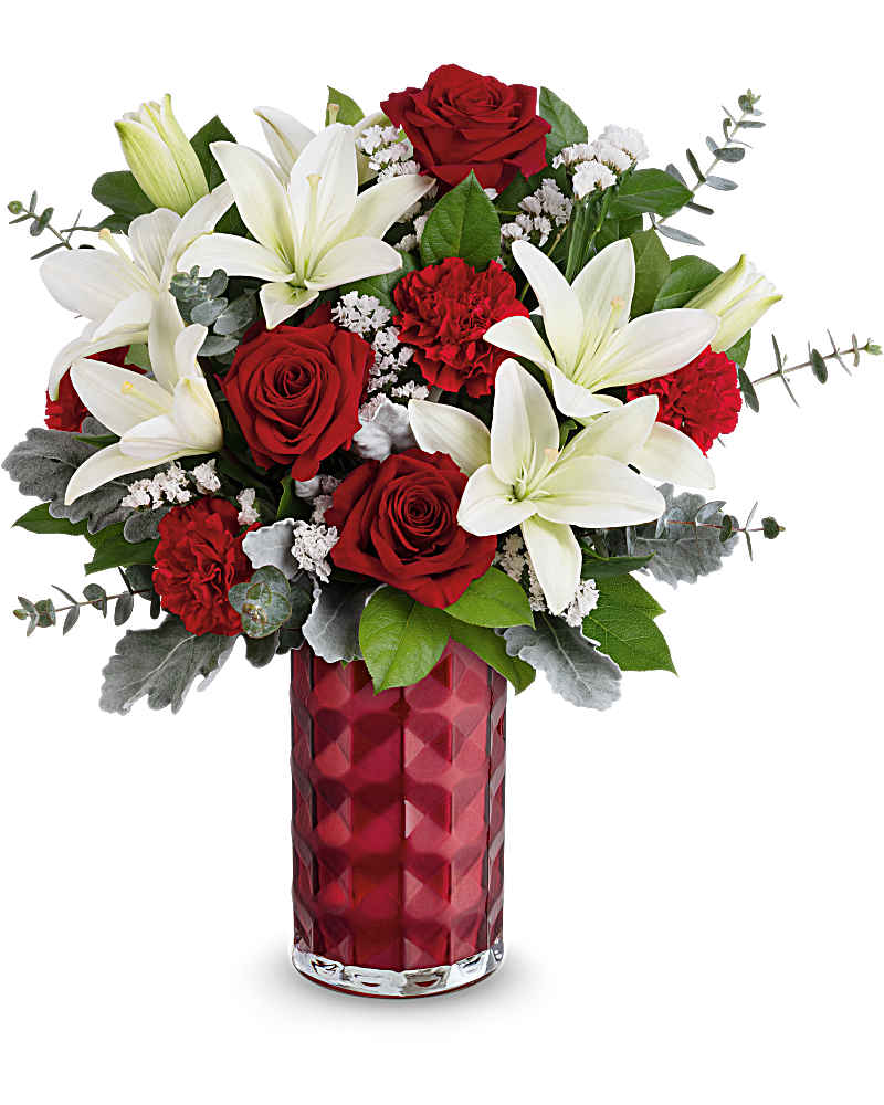Tall red vase arrangement with white lilies, red roses, and red carnations.