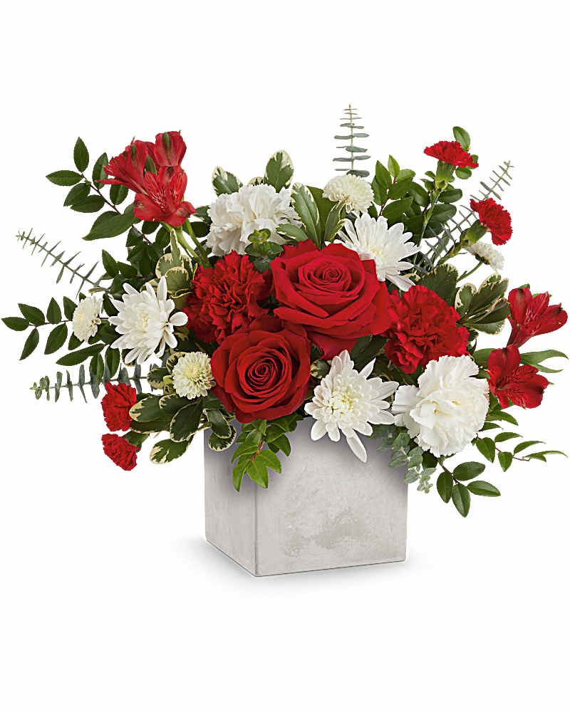 Red roses with white carnations and mums in a square ceramic vase