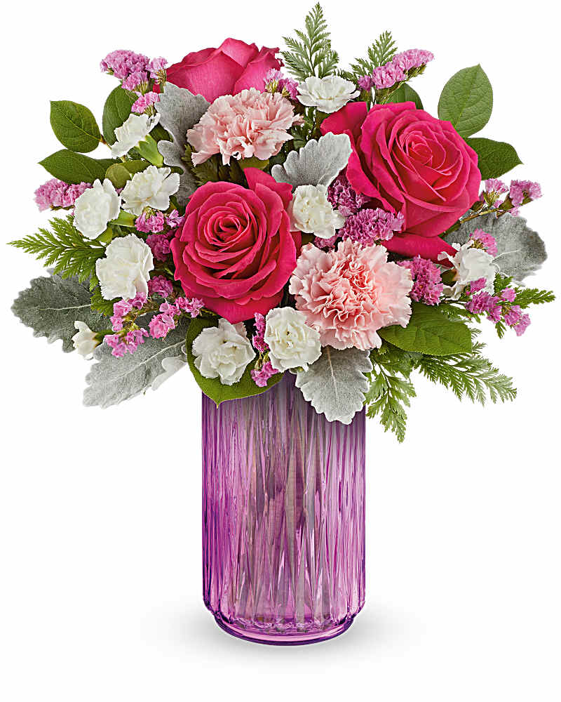 Tall pink vase with hot pink roses, pink and white carnations, and lavender filler flowers