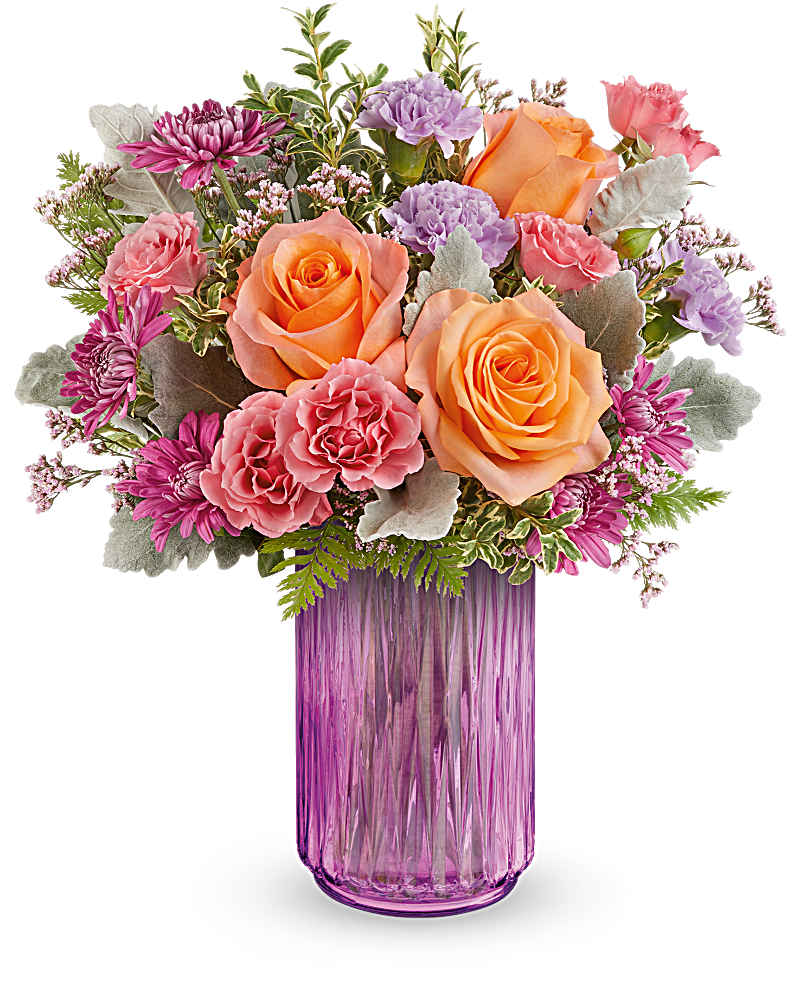 Mixed bouquet of peach roses and pink and purple flowers in a tall purple glass vase