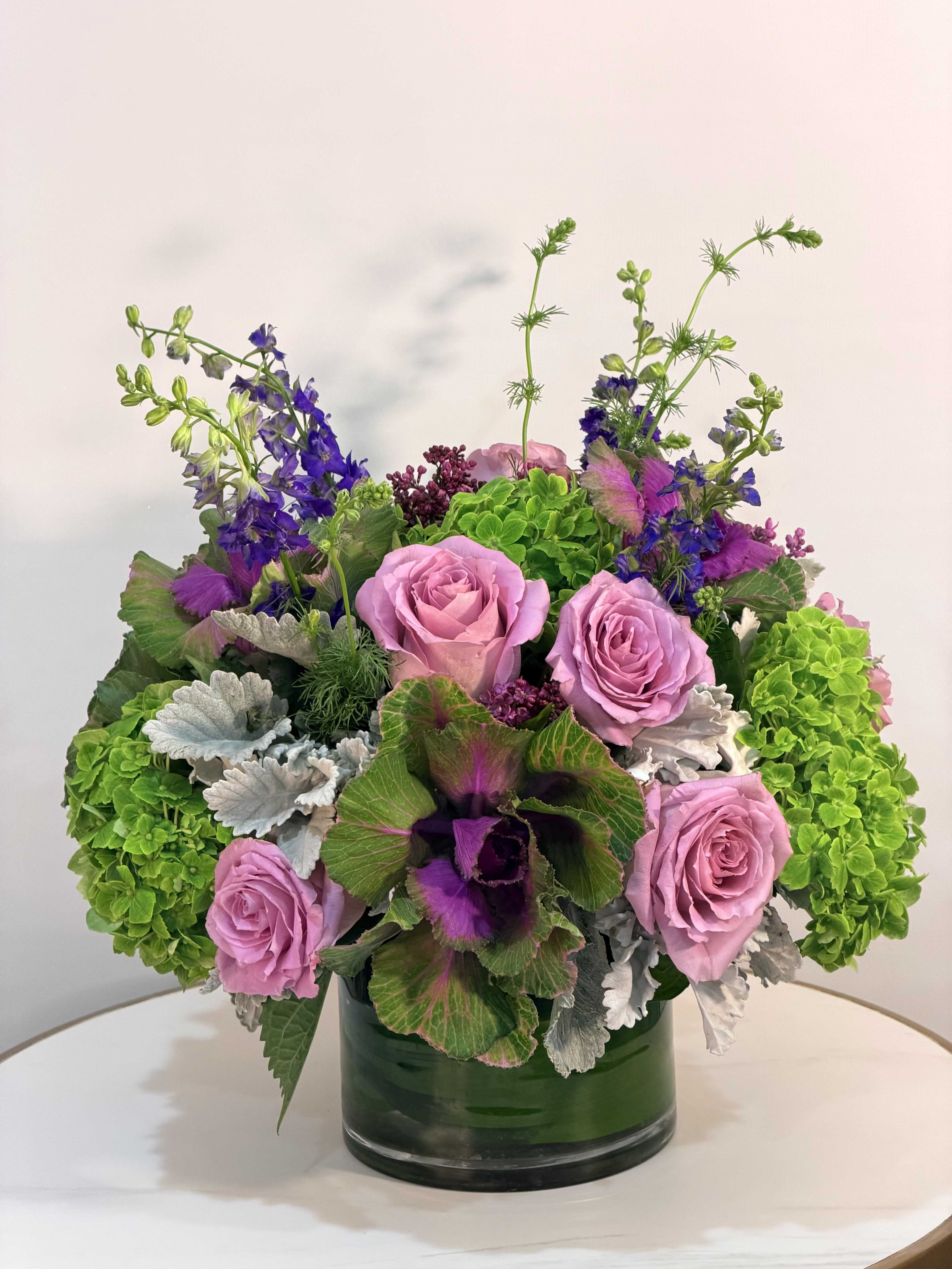 Wild Blush - A striking and artistic floral arrangement featuring soft pink roses, vibrant green hydrangea, and unique seasonal elements with rich textures and movement. Designed in a modern glass vase, this arrangement blends bold color contrasts with natural beauty for a truly eye catching look. The mix of structured blooms and wild greenery creates a fresh, organic feel with a modern edge perfect for those who love something different, creative, and full of life. Handcrafted with premium fresh flowers to ensure long lasting beauty and a standout presentation. Same Day Flower Delivery Available across Beverly Hills, Bel-Air, West Hollywood, Beverly Grove, Santa Monica, Culver City, Hollywood Hills, Hollywood, Studio City, Encino, and Sherman Oaks.