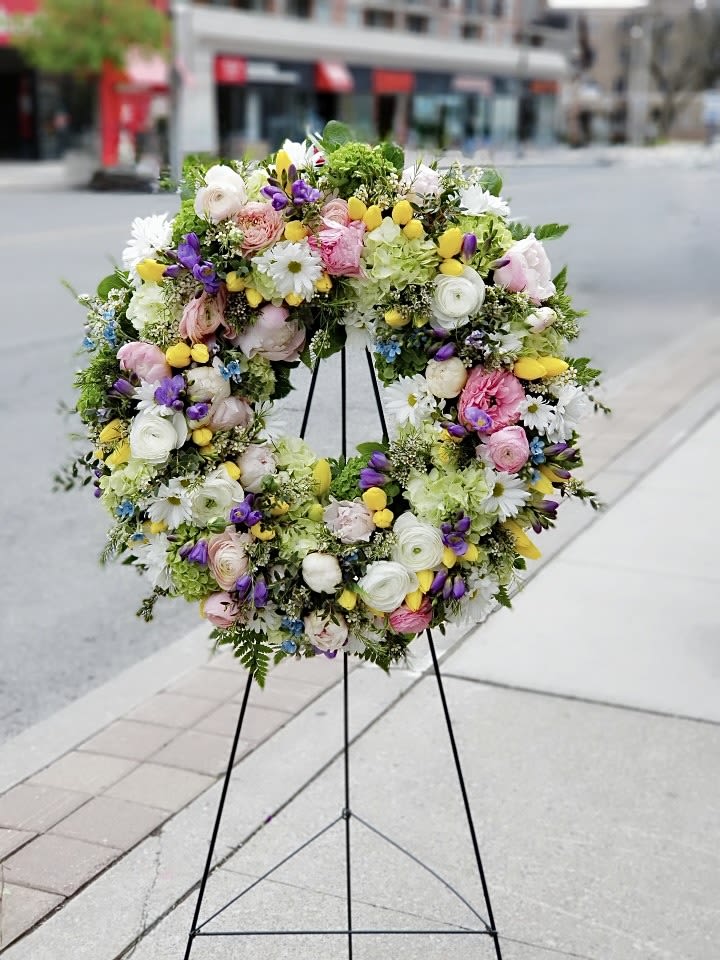 Spring Serenity Wreath - A graceful tribute featuring soft pastel blooms, including delicate roses, tulips, and hydrangeas, accented with lush greenery.