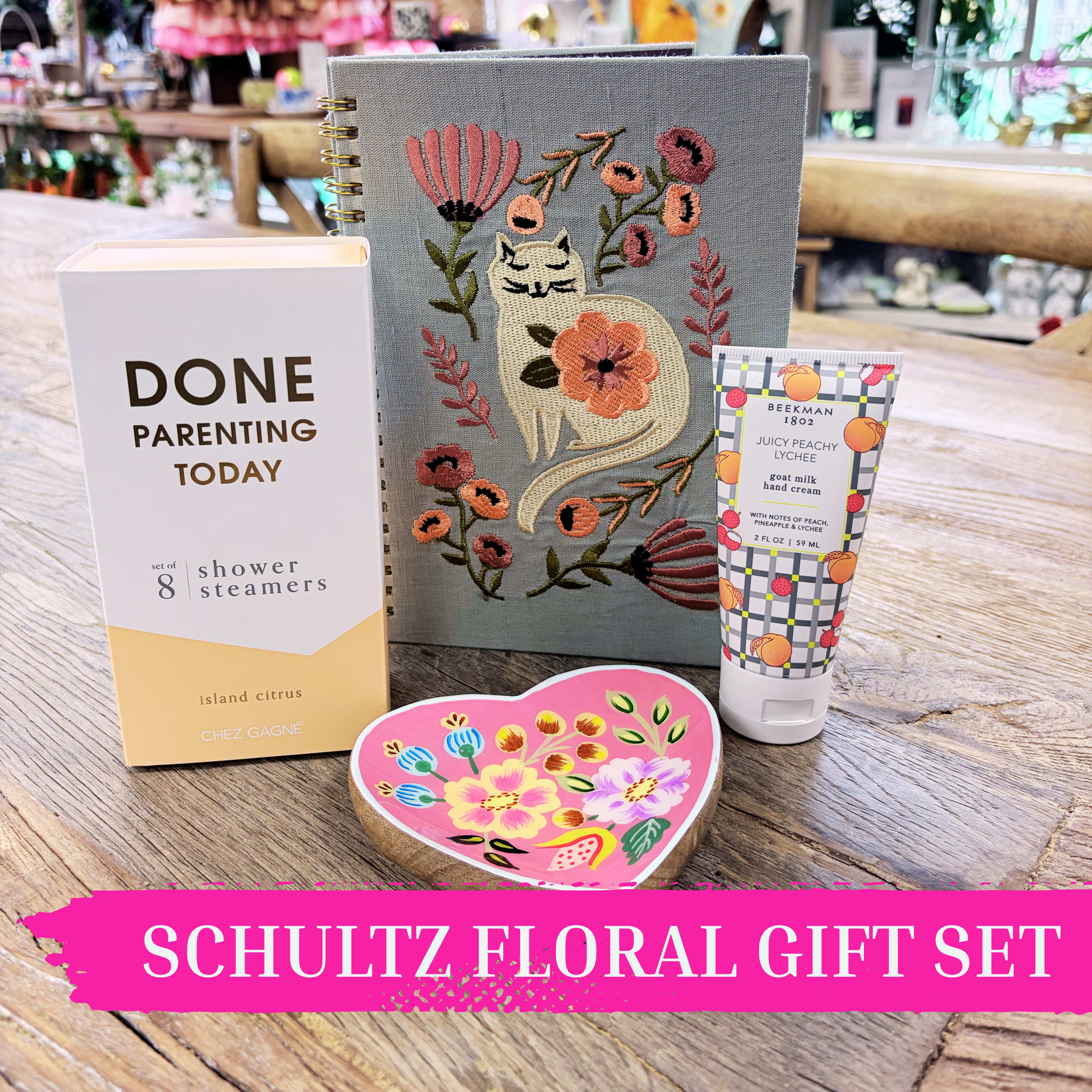“Take a Break” Self-Care Gift Set | Fun &amp; Relaxing Gift Set for Her by Schultz Floral - For the parent (or anyone!) who deserves a little “me time,” this playful self-care gift set is the ultimate pick-me-up. Thoughtfully curated to bring calm, humor, and indulgence, it’s perfect for birthdays, Mother’s Day, or just because.  This rejuvenating collection includes: – Cat-embroidered lined notebook for jotting notes, lists, or reflections – Heart-shaped floral trinket dish, perfect for keepsakes – Beekman 1802 Peach Lychee Goat Milk Lotion (2 oz), a best-selling treat for soft, nourished hands – “Done Parenting” Citrus Shower Steamers (set of 8) for a refreshing at-home spa experience  An easy way to send laughter, love, and a well-deserved pause. Available for Valparaiso pickup or local delivery.