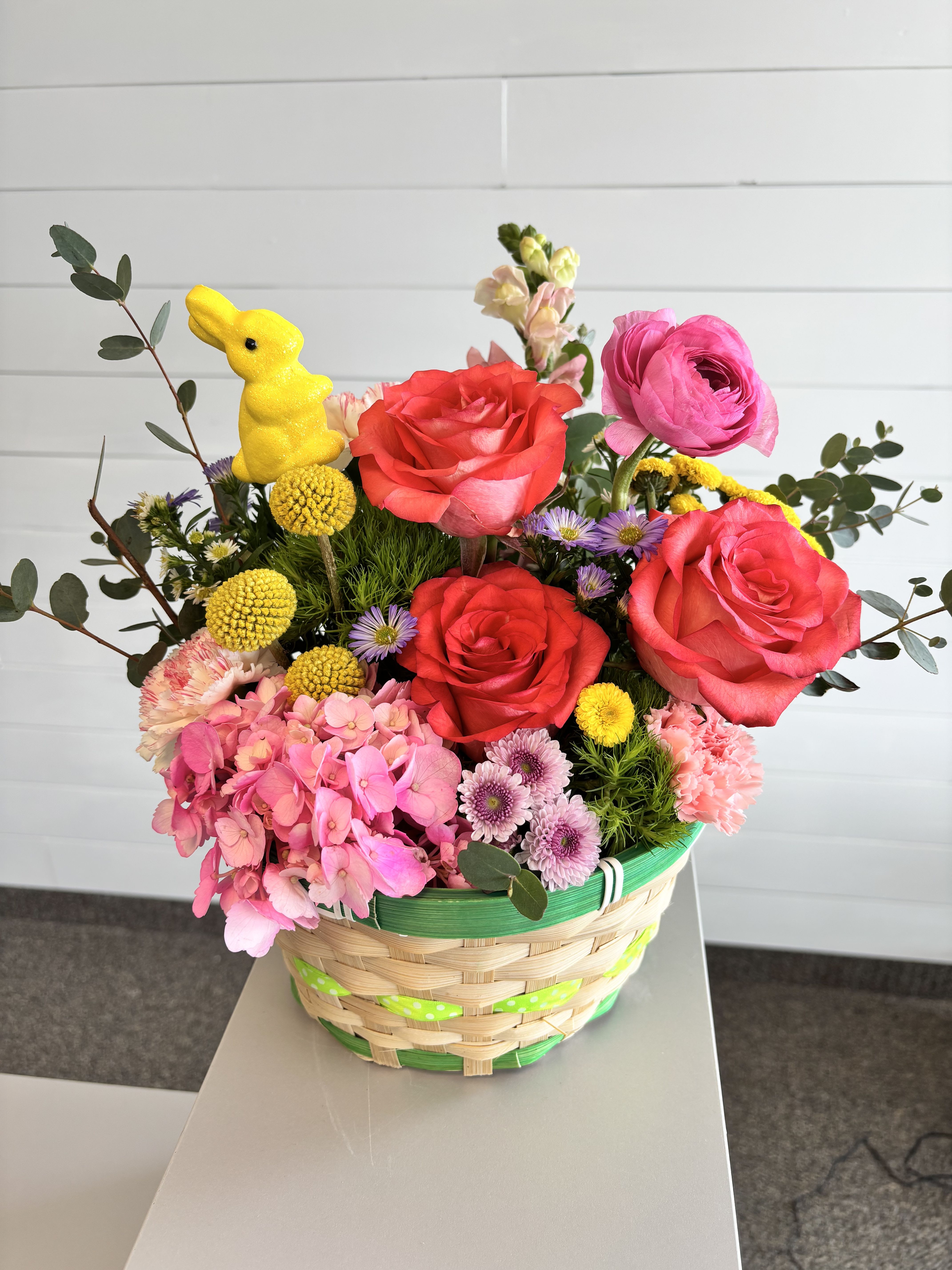 Easter basket - Basket filled with bright cheerful Easter colors. Flower types may vary