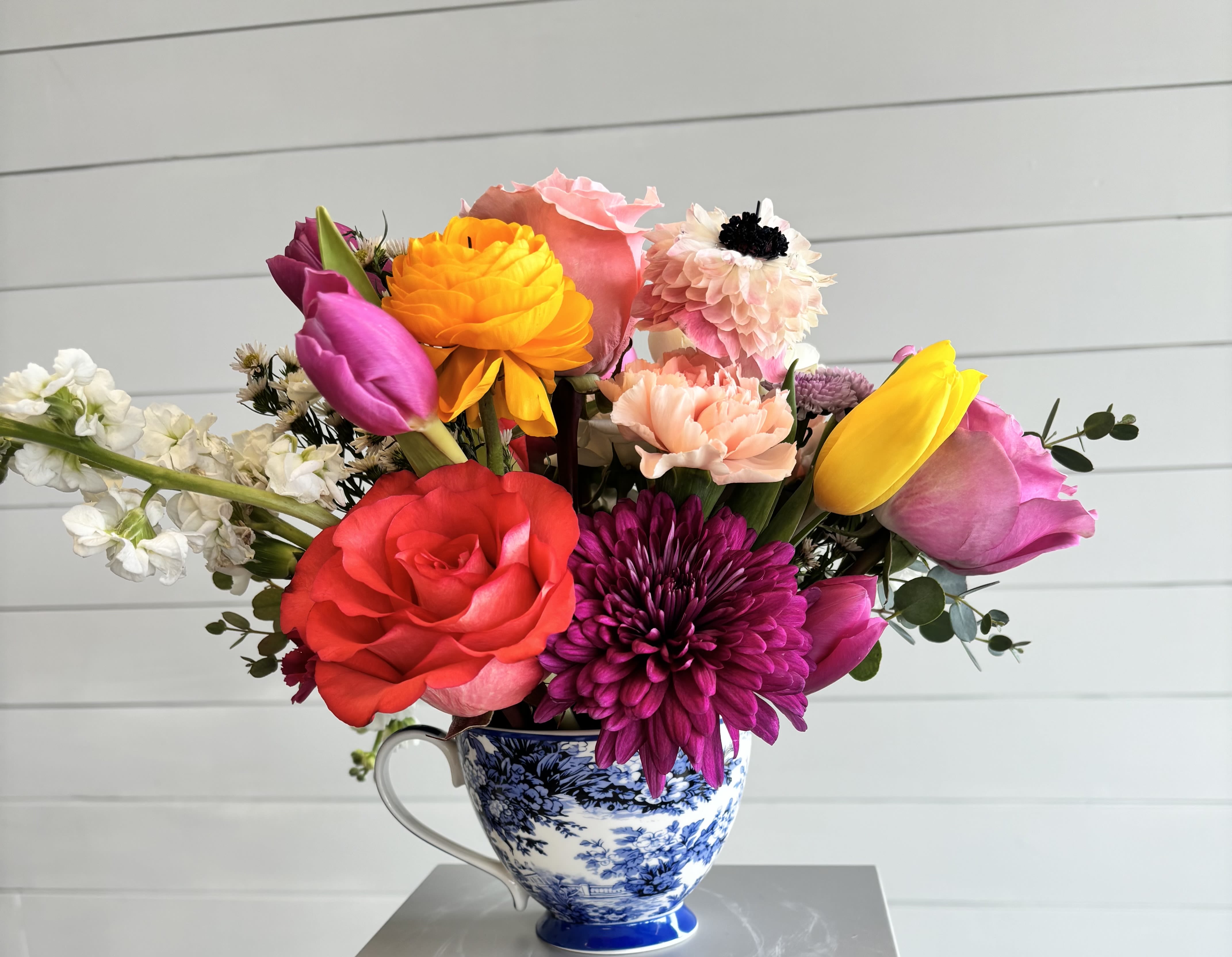 Tea cup blooms - Tea cup of bright in season blooms. Flower types may vary.