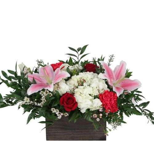 Love Story - Showcasing a wooden rectangular container filled with red roses, pink stargazer lilies, red carnations, and white hydrangea. Celebrate your own Love Story this year by sending this stunning arrangement to the one you love and have your own happily ever after.