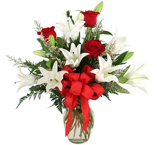 Lovelight - Red for passion... white for love. Glass vase arrangement of love and passion! Featuring roses and  lilies  perfectly arranged and complemented by a delicate organza bow.
