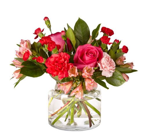 You're Precious Bouquet - Brighten up your home with this gorgeous bouquet. A handcrafted blend of roses, carnations, and more set in a clear glass cylinder vase creates a gorgeous array of intense pink and red blooms.