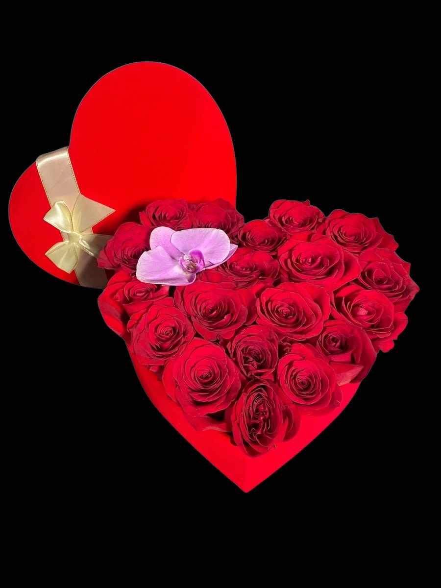 Heartfelt blooms  - Express your deepest emotions with this stunning heart-shaped floral arrangement, a perfect symbol of love and romance. Featuring lush, velvety red roses meticulously arranged in a bold red heart-shaped box, this exquisite bouquet radiates passion and elegance. A delicate orchid rests gracefully among the roses, adding a unique touch of sophistication and charm.