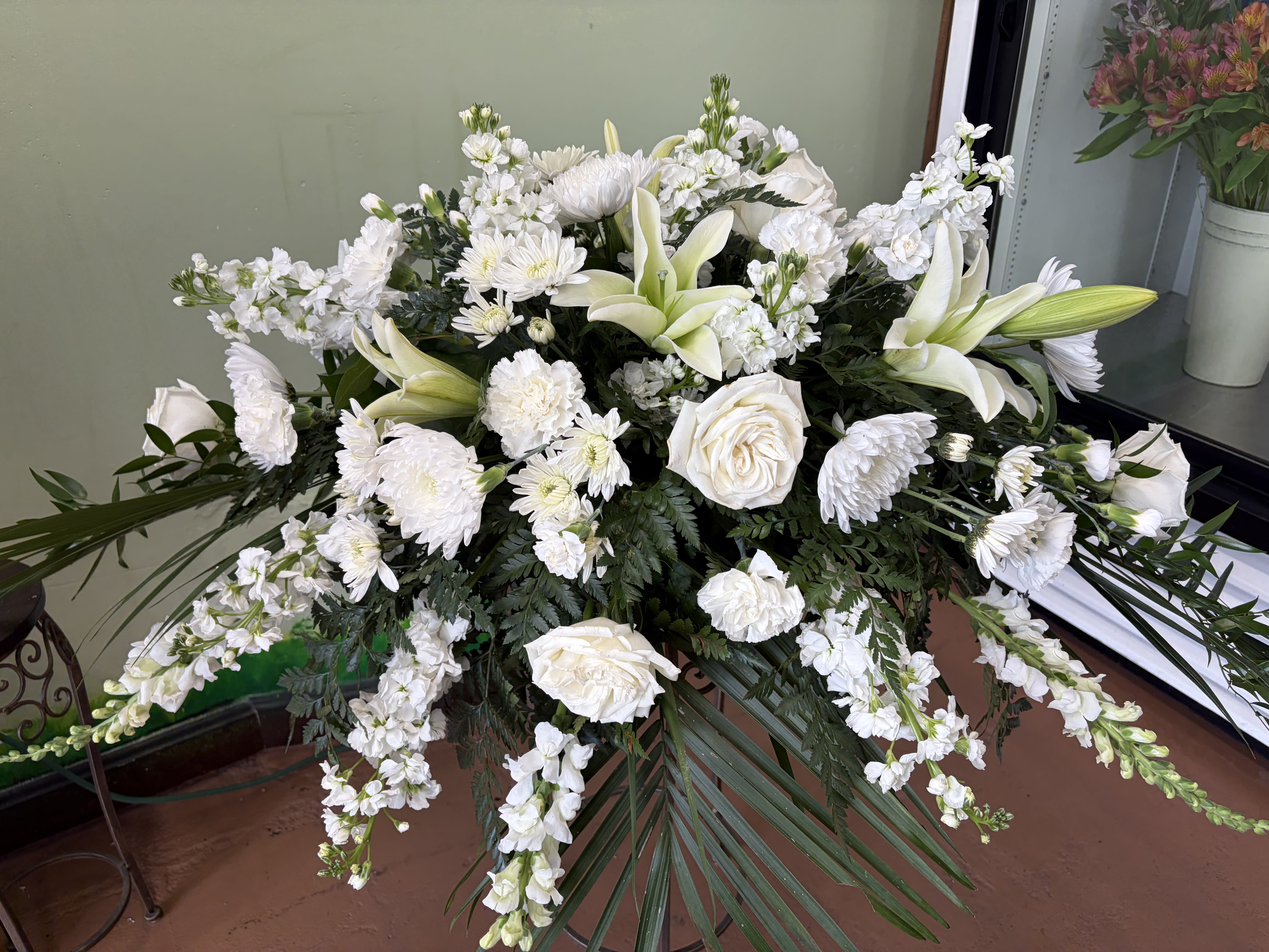 Heavenly White Farewell Casket Piece - A soft and elegant casket spray designed to honor a life with peace and grace. The flowing shape and gentle white tones create a calm and comforting tribute, offering a beautiful way to express love, remembrance, and sympathy.