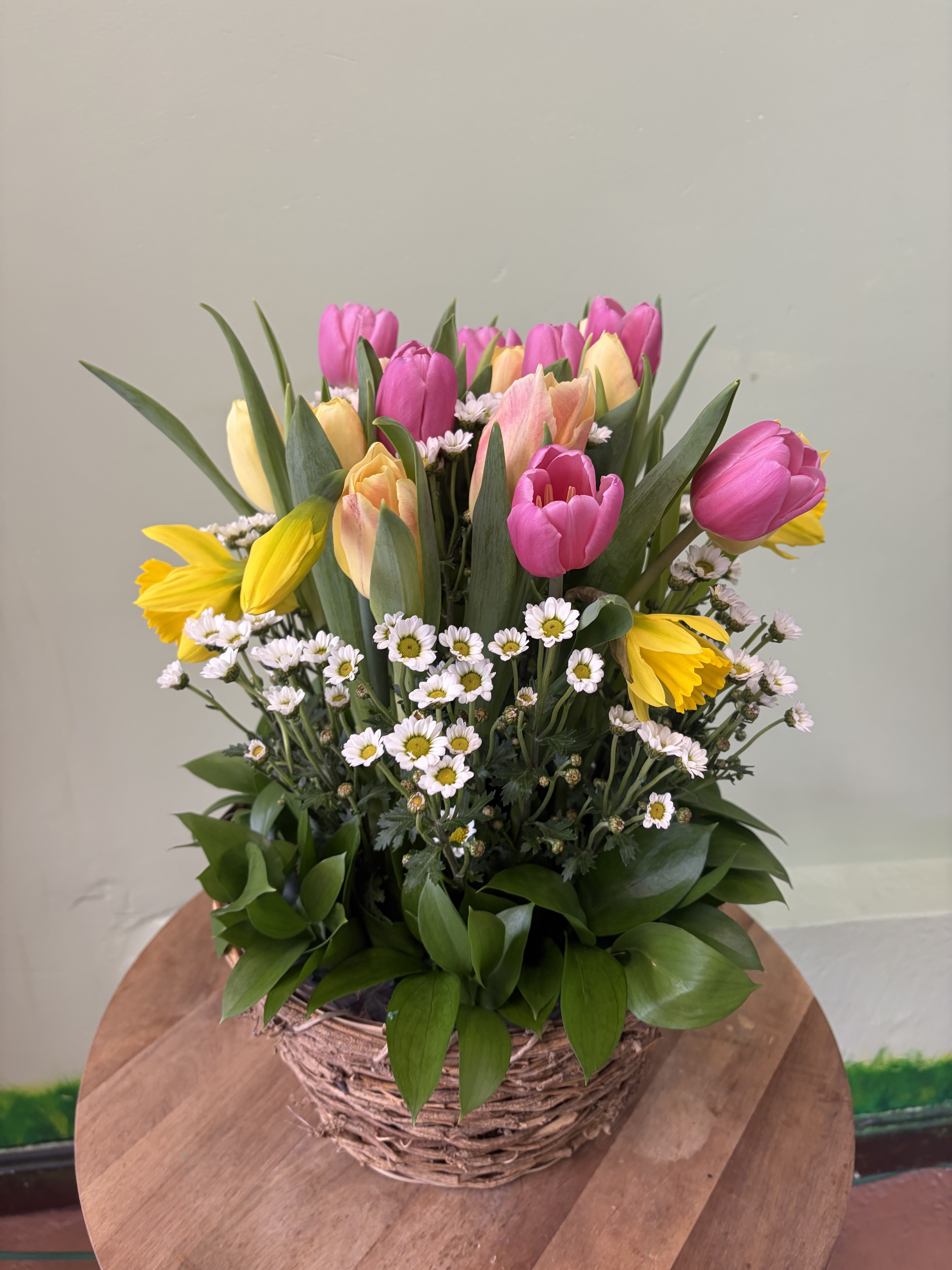 Spring Tulip Garden - A fresh and vibrant mix of assorted tulips, accented with delicate fillers and rich green leaves.