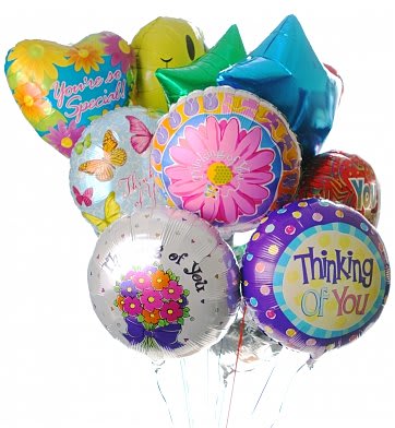 Bunch of colorful round, heart, and star-shaped mylar balloons with cheerful messages.