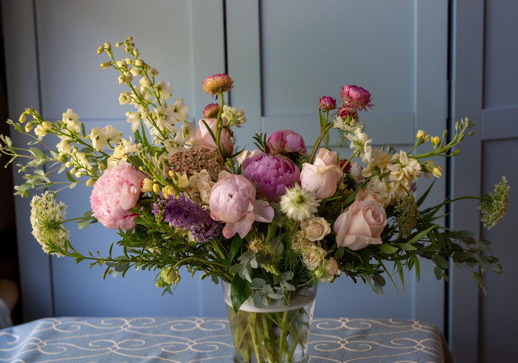Soft and Feminine - Pale creams, yellows, pinks in this beautiful garden design with tall stems, is perfect for a kitchen island, foyer or anywhere they can be enjoyed.  