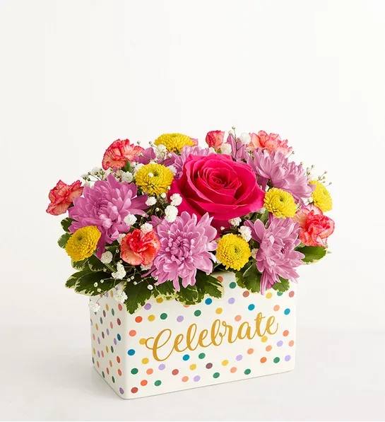 Celebrate the Day Flower Bouquet - Whatever the occasion, make it one filled with color and joy. From the vibrant mixed bouquet to the polka-dotted ceramic vase with “Celebrate” on the front in gold, this gift is cause for celebration in and of itself. And if the special occasion is a birthday, add to the fun with a lively “Happy Birthday” balloon.