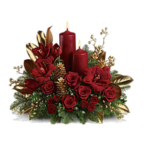 Red rose and amaryllis centerpiece with two red candles, gold pinecones, and gold leaves.