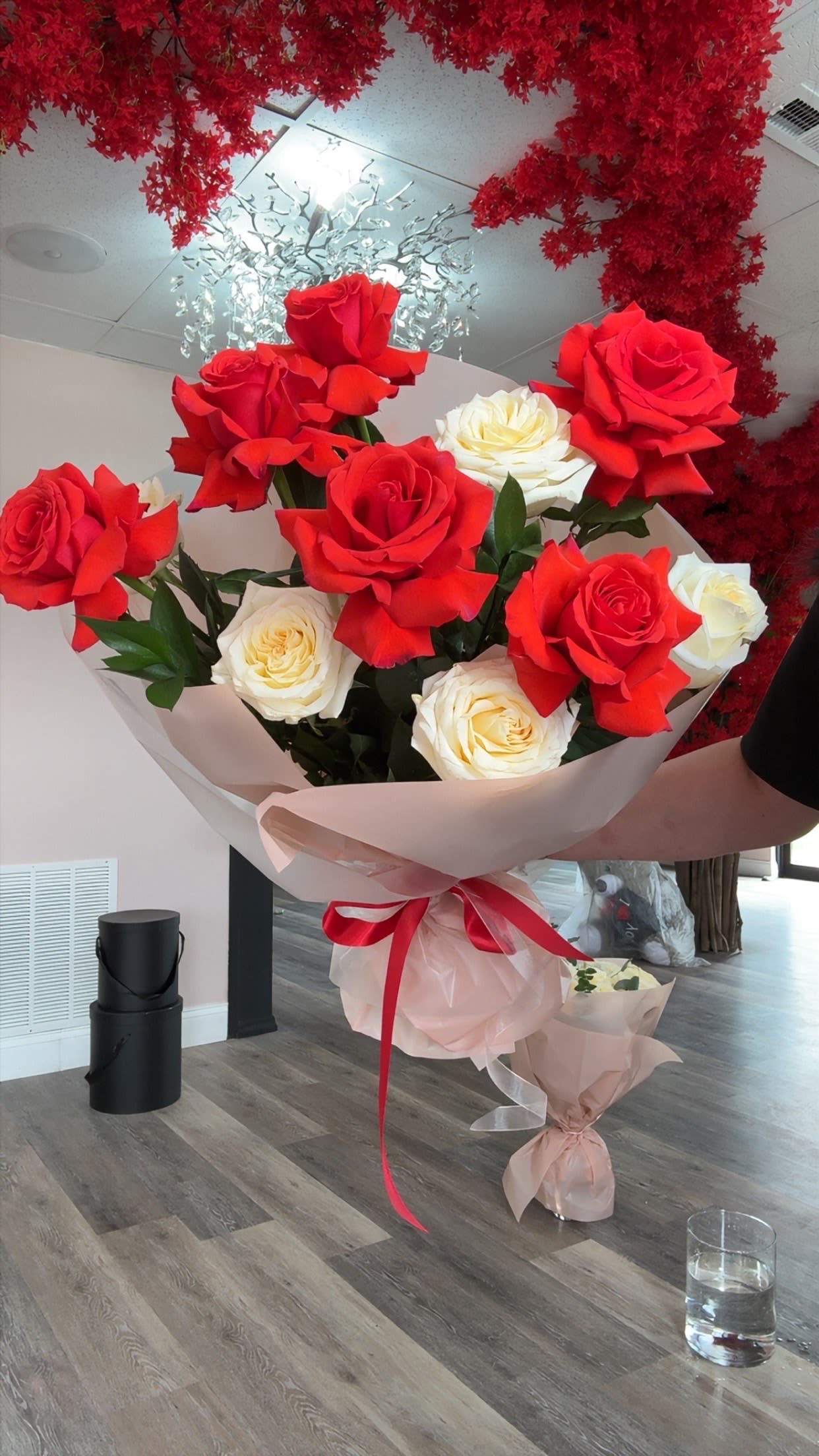 Forever Yours - This bouquet is a stunning mix of French red and soft ivory roses, creating a perfect balance of passion and elegance. The rich red roses stand out beautifully againstthe creamy white blooms, giving it a romantic and timeless look. Its wrapped in a soft blush-toned paper and finished with a delicate red ribbon.