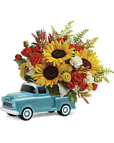 Chevy Pickup Bouquet - T18F100 approx. 11 1/2" h x 13 1/2" w  Beep beep! Dad's sure to love this colorful Father's Day bouquet of spray roses and sunflowers riding in the back of a classic Chevy pickup. This hand-painted, hand-glazed ceramic design is a cool keepsake he'll treasure forever! It's one of the ways we're commemorating the 100th Anniversary of ChevyTrucks. •This bouquet includes orange spray roses, small yellow sunflowers, miniature white carnations, yellow button spray chrysanthemums, red leucadendron, solidago, sword fern, dusty miller, variegated pittosporum, and parvifolia eucalyptus.  •Delivered in a Chevy Pickup Keepsake. * Arrangement is small to medium size* 