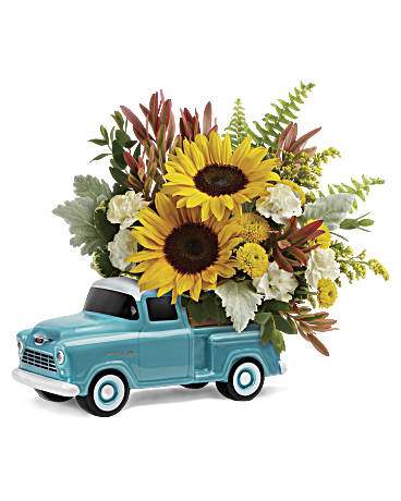 Chevy Pick Up Bouquet  - Beep beep! Lovely colorful bouquet of spray roses and sunflowers riding in the back of a classic Chevy pickup. This hand-painted, hand-glazed ceramic design is a cool keepsake to treasure forever! It's one of the ways we're commemorating the 100th Anniversary of ChevyTrucks. This bouquet includes orange spray roses, small yellow sunflowers, miniature white carnations, yellow button spray chrysanthemums, red leucadendron, solidago, sword fern, dusty miller, variegated pittosporum, and parvifolia eucalyptus. Delivered in a Chevy Pickup Keepsake. * Arrangement is a small to medium size* 
