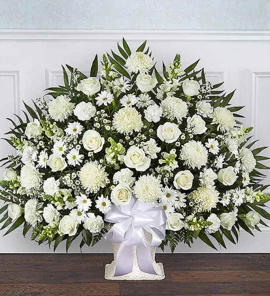 Heartfelt Tribute White Floor Basket Arrangement - All-white floor basket arrangement of roses, football mums, snapdragons, carnations, daisy poms and monte casino; accented with soft, lush greenery Large arrangement measures approximately 34"H x 38"L Small arrangement measures approximately 32"H x 32"L Appropriate for the funeral home Our florists use only the freshest flowers available, so colors and varieties may varyge