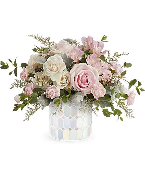 Rosy Skies - Illuminate love with the Rosy Skies bouquet, embracing soft pastel shimmer and cradling an exquisite bouquet of vibrant pink flowers, a timeless expression of artistic beauty for any occasion. Embrace enchantment with a delicate bouquet of light pink roses, crème spray roses, light pink alstroemeria, miniature pink carnations, and parvifolia eucalyptus, all in Teleflora's Alluring Mosaic cylinder which makes a radiant gift for any celebration.
