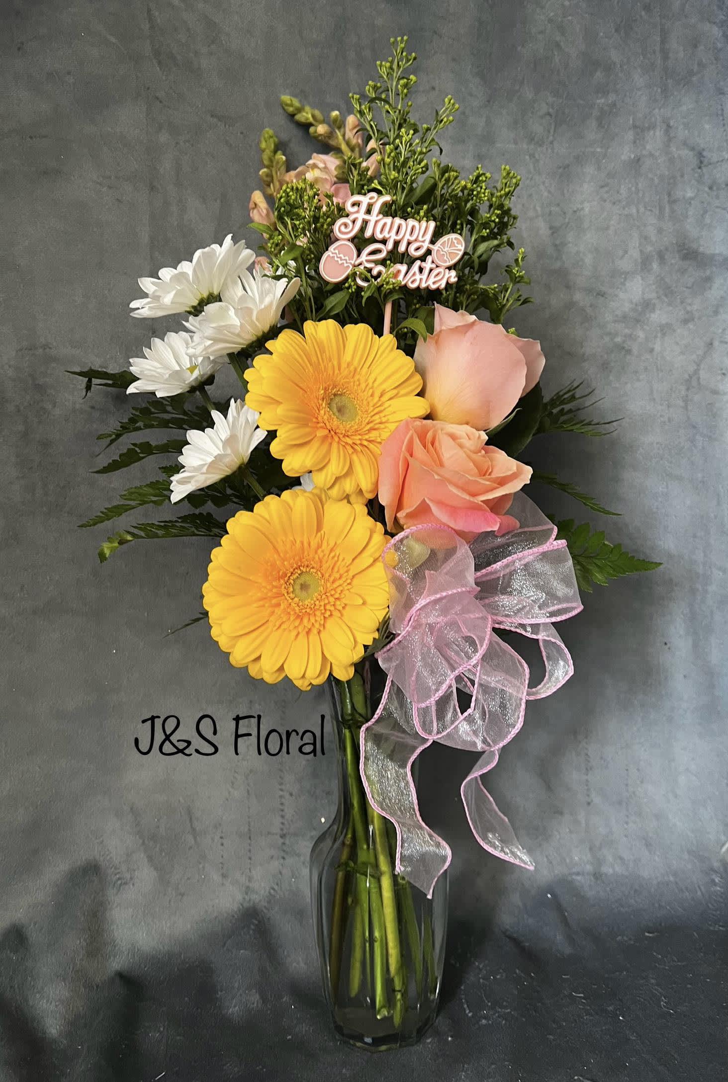 Spring Morning  - Introducing Our New Design Spring Morning, where elegance meets nature's artistry. Embrace the beauty of our latest creation, meticulously crafted to bring a touch of floral enchantment into your world.  Beautifully handmade with yellow gerberas, pink roses, pink snapdragon, white daisies, fillers and greenery 