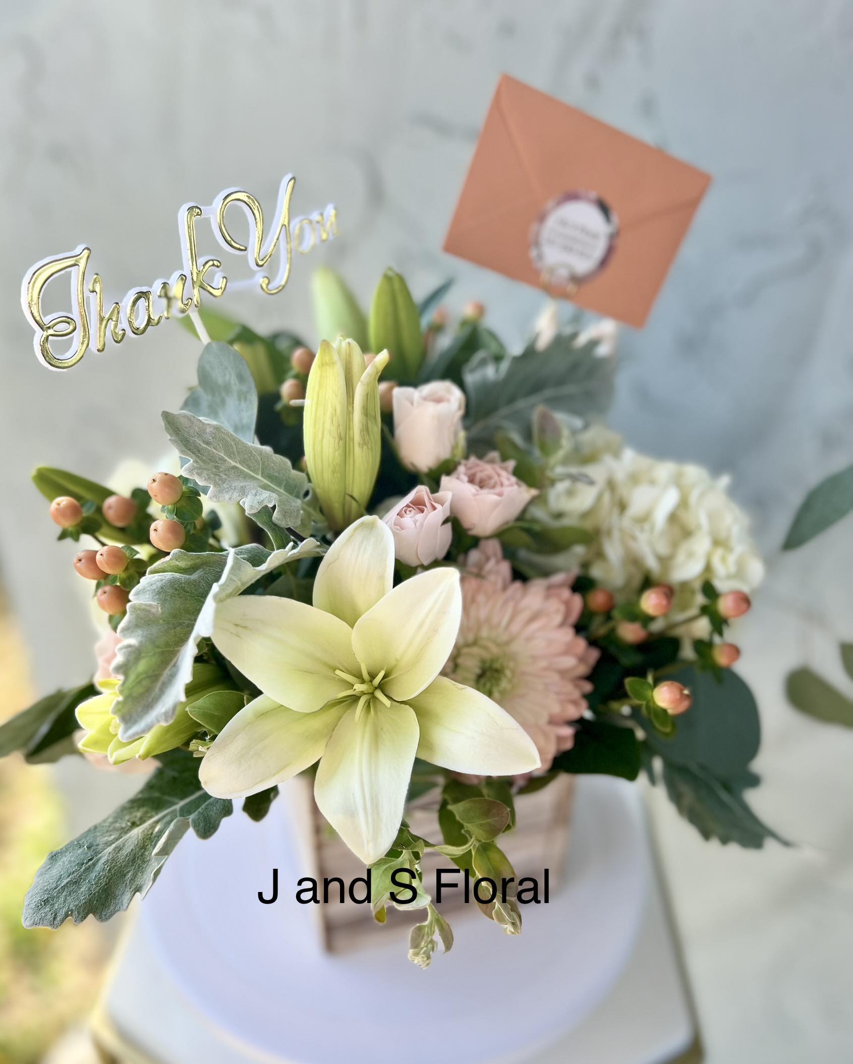 Peachy Blooms - Introducing our design Peachy Blooms. Beautifully arranged with lilies, mums, hydrangeas, fillers and greenery in a wooden box. 