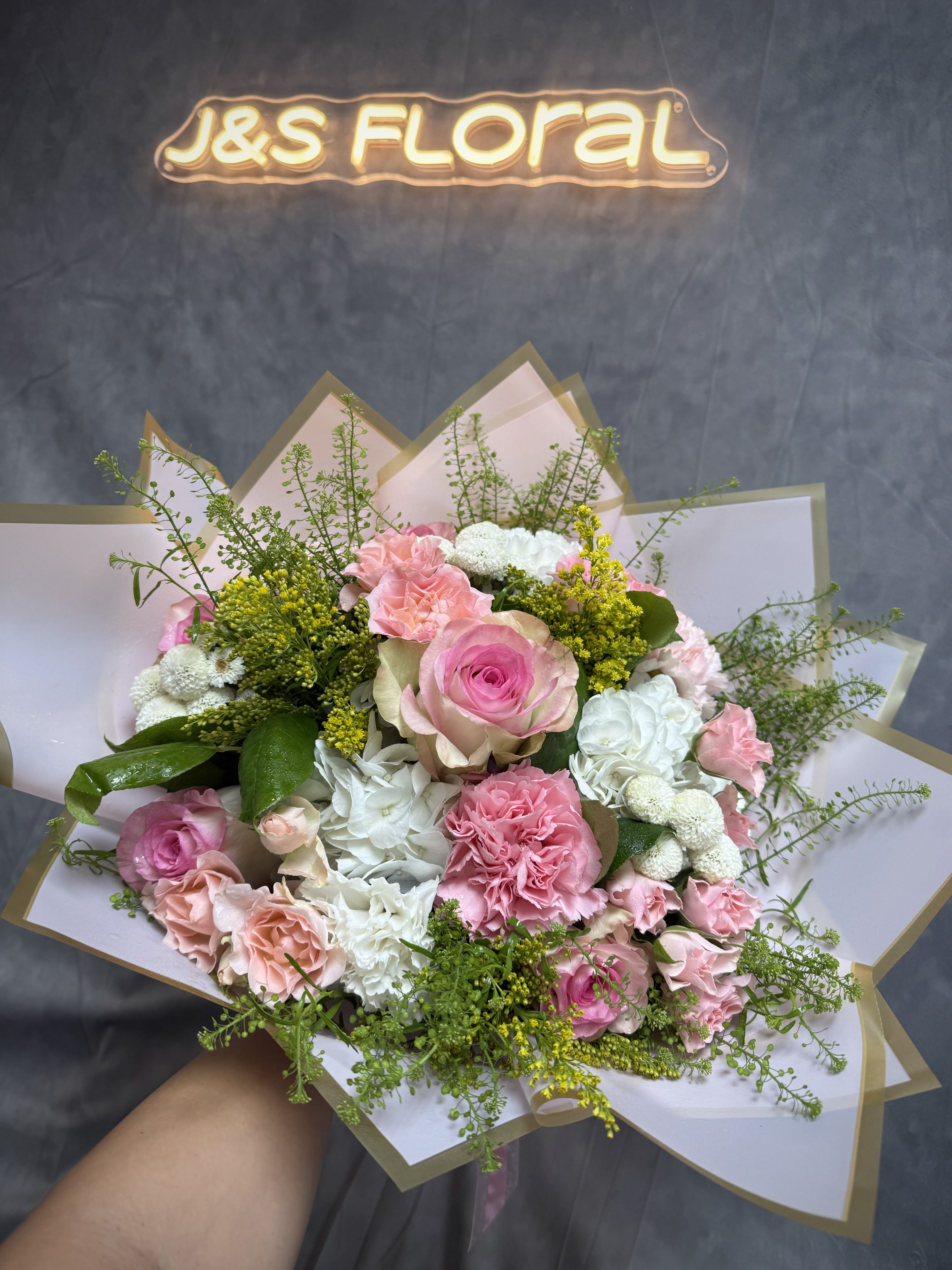 Blushing clouds bouquet - A beautiful bouquet of pink roses &amp; carnations with white hydrangeas , buttons and carnation with greenery. Together, they create a harmonious blend perfect for any occasion. 