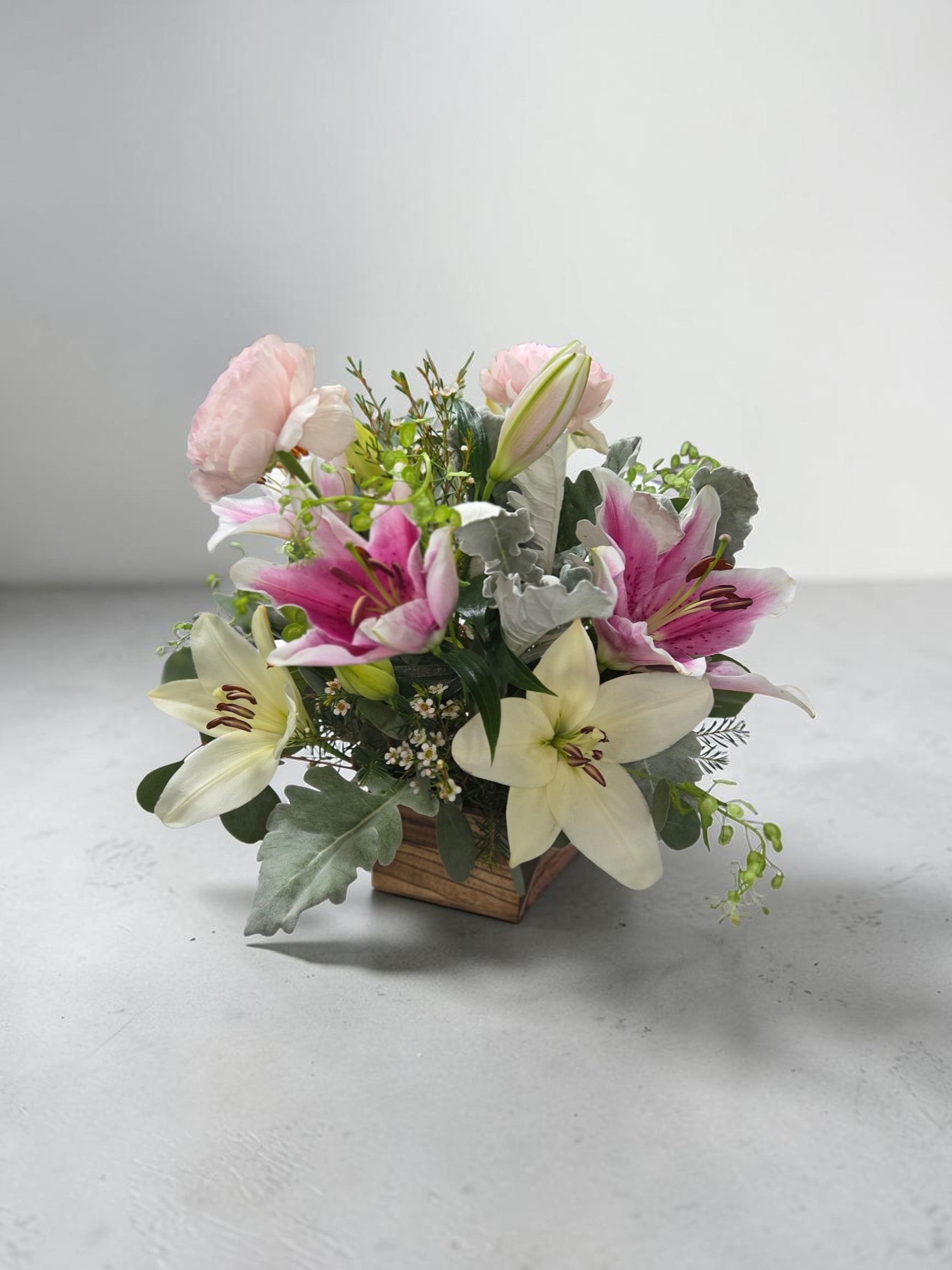 Soft Spoken - Soft lilies, with white and pink with soft touches of dusty miller and ranunculus.