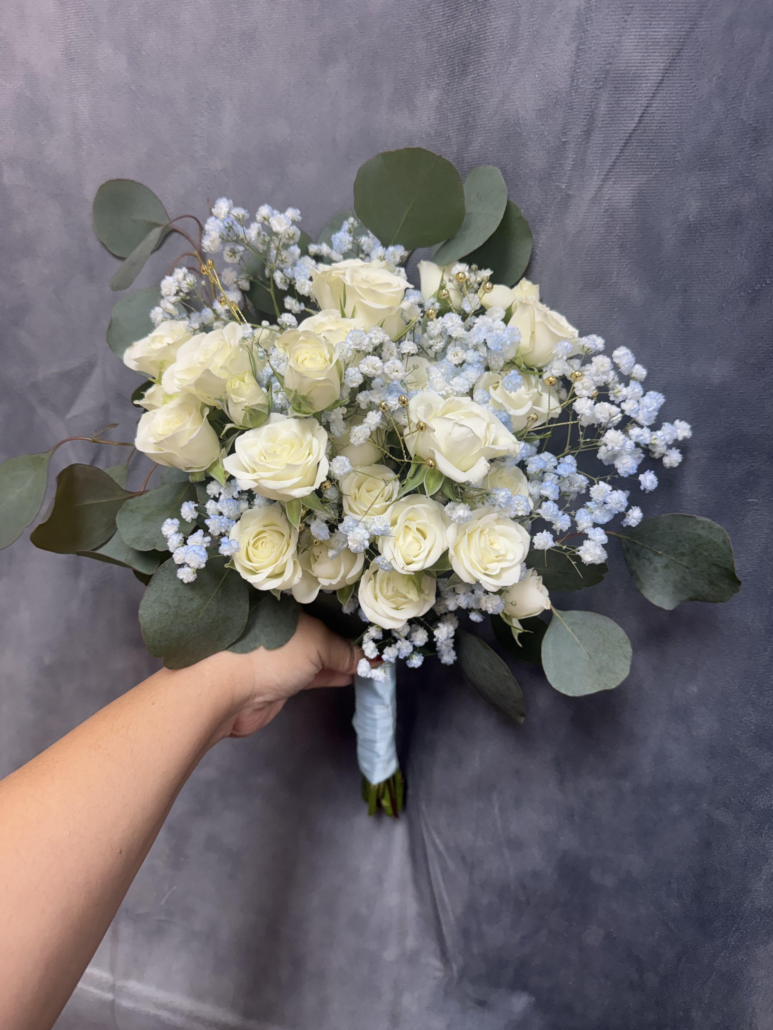 Blue ice prom bouquet  - Blue ice prom bouquet with white spray roses and light blue baby breath 