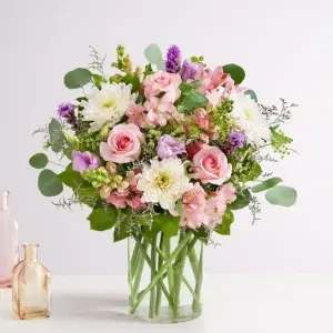 Floral Meadow - The charming beauty of a spring meadow, made just for Mom. Our luxurious bouquet is gathered with a garden-fresh mix in shades of pink, purple and white Artistically designed in a glass cylinder vase, this Mother’s Day gift delivers the best part of the season to someone you love.