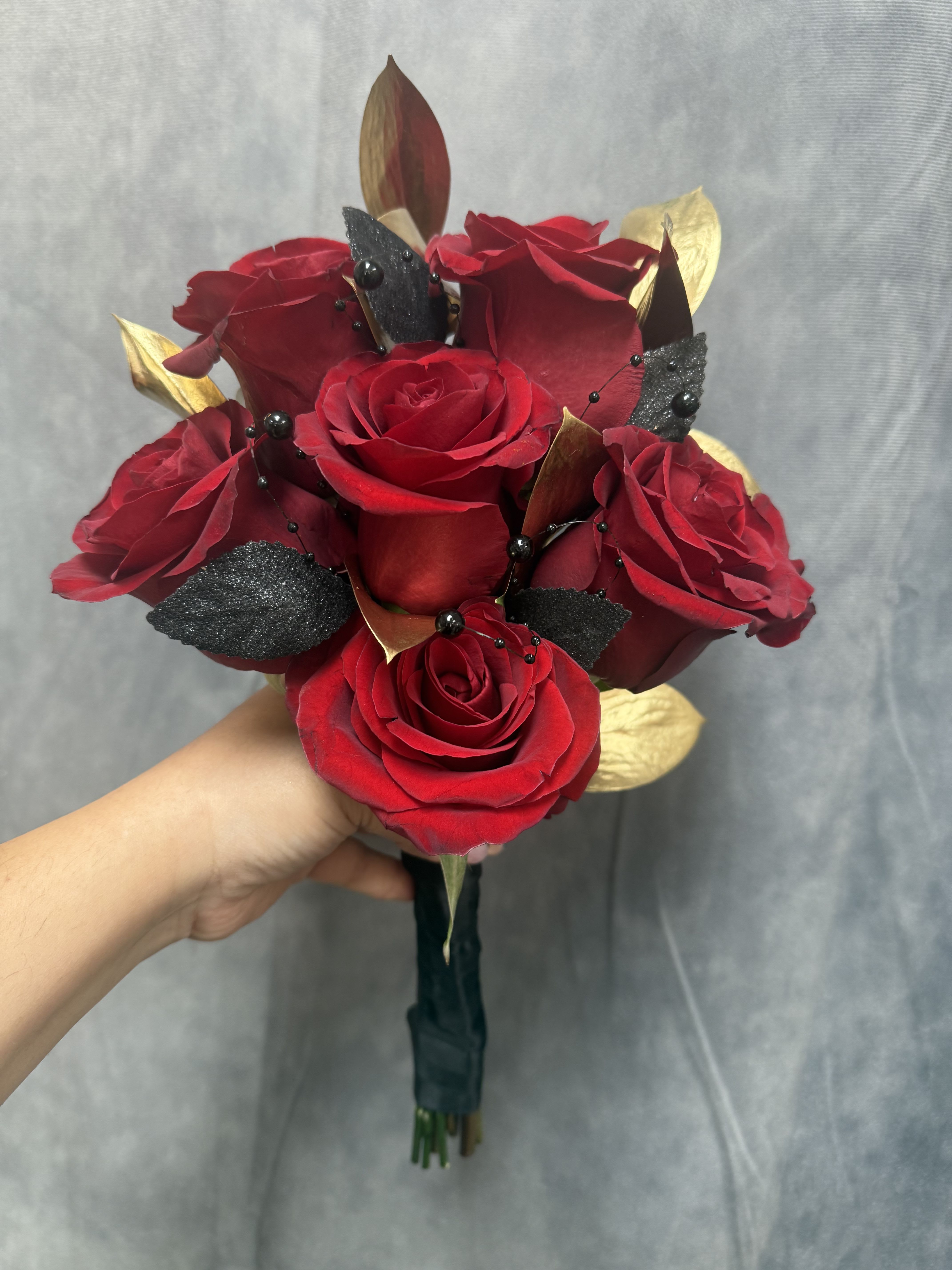 Prom red gold black bouquet - Prom red , gold and black bouquet made with red roses , gold ruscus, black leaves and black pearls 