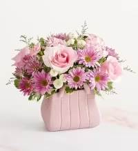 Designer Dreams Bouquet - The ultimate arrangement for your favorite fashionista. A profusion of roses, poms, and other blooms all but spill out of the top of our keepsake handbag-shape vase, making this a truly chic gift. 