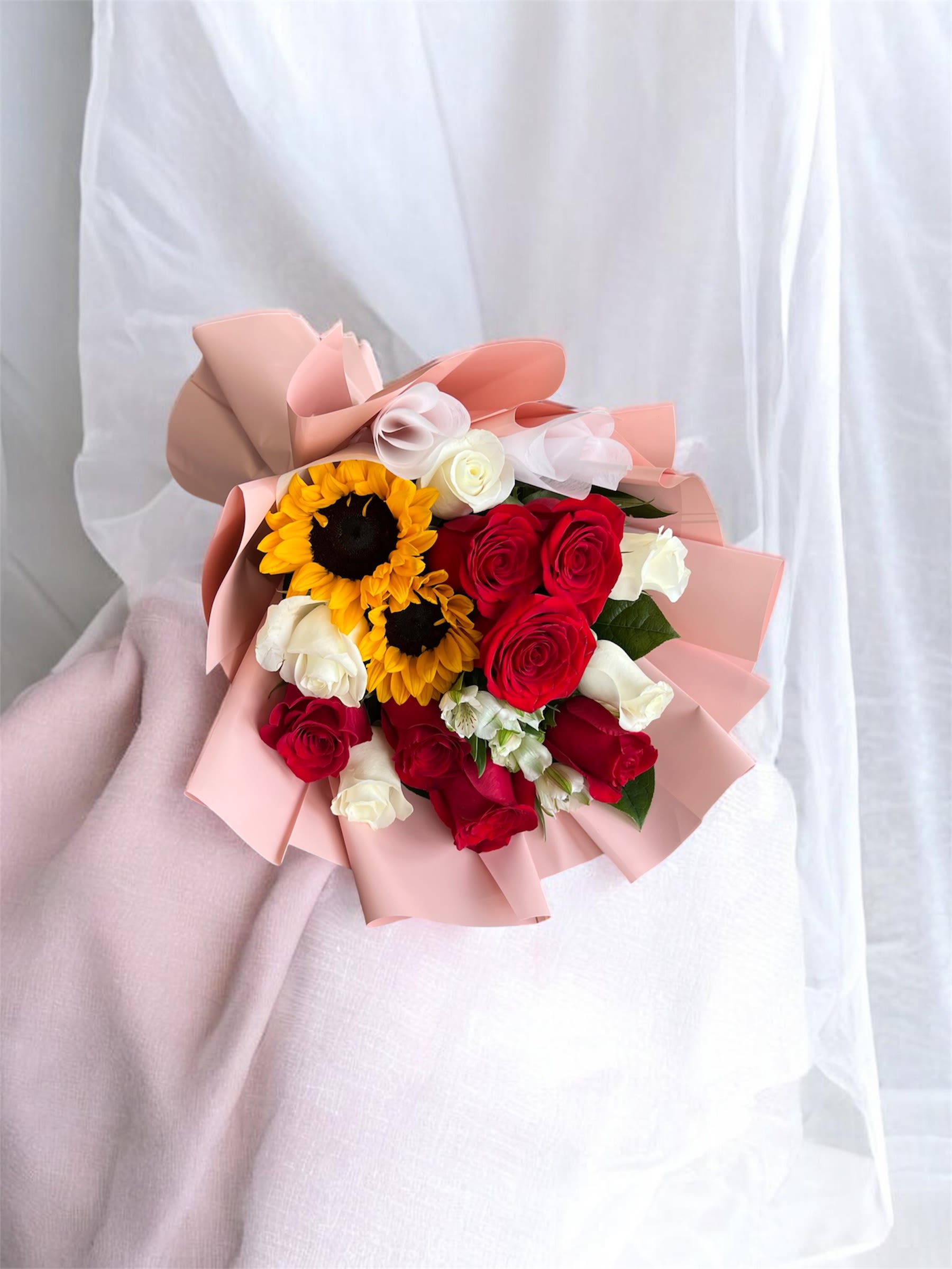 Sunflower Serenade Bouquet  - A stunning blend of golden sunflowers, red and white roses, artfully wrapped in elegant paper. This bouquet radiates warmth and elegance!
