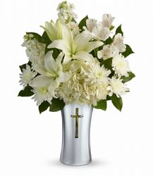 Shining Spirit Bouquet - A shining tribute to a life well lived, this pure white bouquet of hydrangea and lilies is arranged in a beautiful ceramic vase with gleaming metallized finish and reverent cross cut-out. It's a lovely gift of remembrance for the home or service. White hydrangea, white asiatic lilies, white alstroemeria, white stock, and white cushion spray chrysanthemums are accented with lemon leaf.