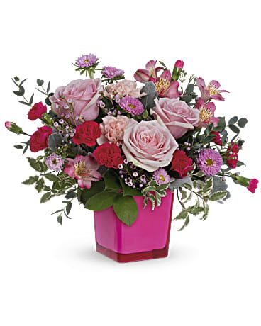 Rosy Moment Bouquet - Make the moment magical with this joyful pink rose bouquet in a keepsake fuchsia glass cube. Pink roses, dark pink alstroemeria, pink carnations, miniature hot pink carnations and pink matsumoto asters are arranged with lemon leaf, pink waxflower, dusty miller and pitta negra. Delivered in a Color Splash cube.