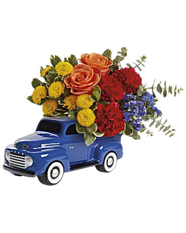 Ford Vintage Truck Bouquet  - Special delivery! Send a smile with this colorful bouquet, delivered in the bed of a hand-glazed ceramic Ford pickup keepsake vase. This bouquet includes orange roses, red carnations, yellow button spray chrysanthemums, blue sinuata statice, spiral eucalyptus and variegated pittosporum. Ford Vintage Truck Bouquet is delivered in a '48 Ford Pickup Keepsake. * Arrangement is a small to medium size*