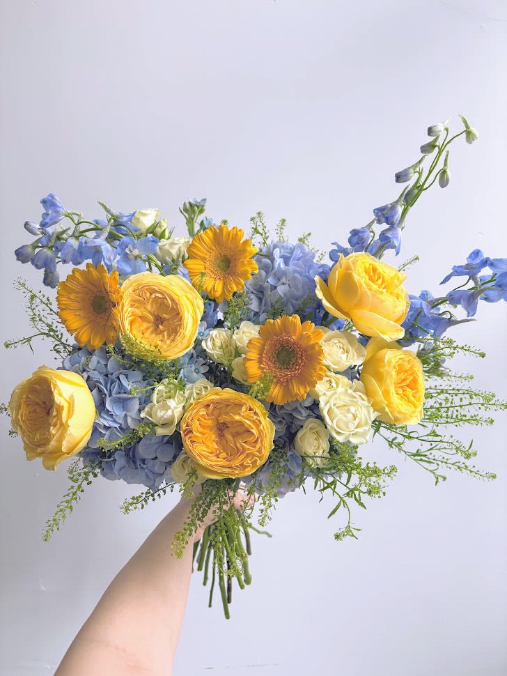 Sunny Skies - A beautiful day: yellow sun and white clouds on a blue sky.