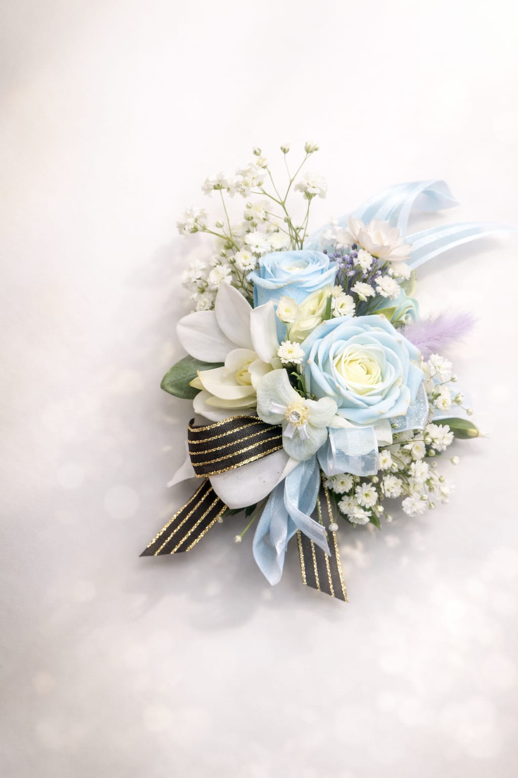 Corsage 10 - This beautiful corsage made with white dendrobium orchid , white spray roses, baby's breath and black ribbon 